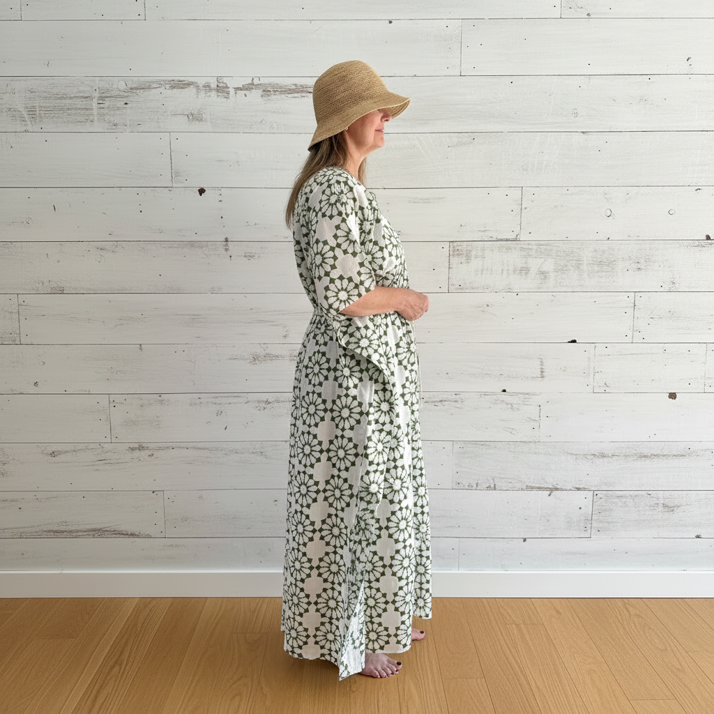 Olive green daisy kaftan in beach house setting with rustic wall