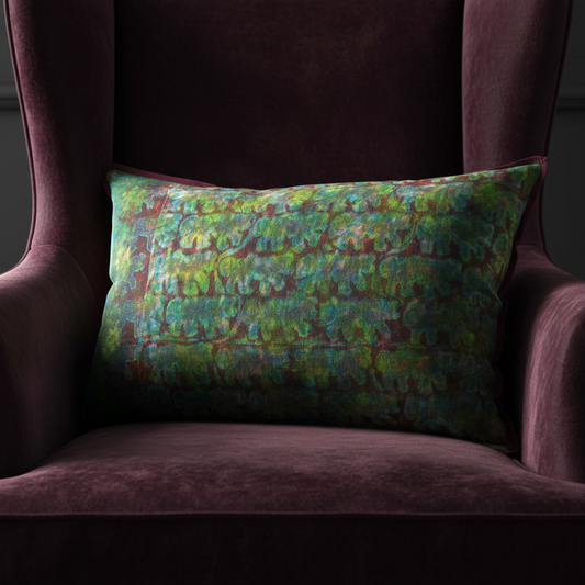 Editorial close-up of artisan cushion on dark damson velvet chair