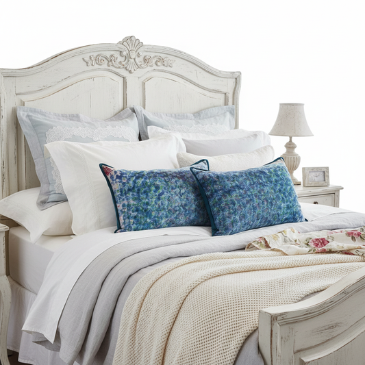 Shabby chic luxury bed setting with artisan cushions