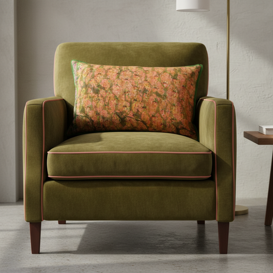 Waterlily 1 cushion on luxurious olive green rolled arm velvet chair with coral piping