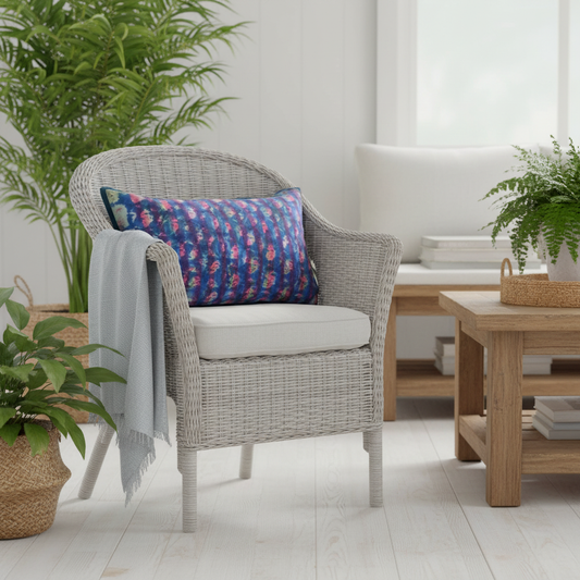 Beach vibe white wicker chair with squishy artisan cushion and plants